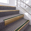 Satin Bronze single insert chevron stair nosing, 65mm riser with Dark Green insert, fitted on carpeted stairs