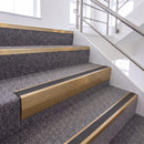Satin Bronze single insert chevron stair nosing, 65mm riser with Dark Grey insert, fitted on carpeted stairs