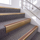 Satin Bronze single insert chevron stair nosing, 65mm riser with Mid Brown insert, fitted on carpeted stairs