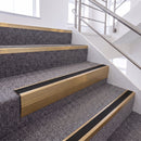 Satin Bronze single insert chevron stair nosing, 65mm riser with Premium Black insert, fitted on carpeted stairs