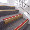 Satin Bronze single insert chevron stair nosing, 65mm riser with Red insert, fitted on carpeted stairs