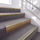 Satin Bronze single insert chevron stair nosing, 65mm riser with Sage Green insert, fitted on carpeted stairs