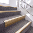 Satin Bronze single insert chevron stair nosing, 65mm riser with White insert, fitted on carpeted stairs
