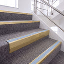 Satin Gold single insert chevron stair nosing, 65mm riser with Aura insert, fitted on carpeted stairs