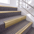 Satin Gold single insert chevron stair nosing, 65mm riser with Beige insert, fitted on carpeted stairs