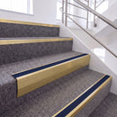 Satin Gold single insert chevron stair nosing, 65mm riser with Dark Blue insert, fitted on carpeted stairs