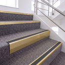 Satin Gold single insert chevron stair nosing, 65mm riser with Dark Grey insert, fitted on carpeted stairs
