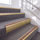 Satin Gold single insert chevron stair nosing, 65mm riser with Mid Brown insert, fitted on carpeted stairs