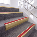 Satin Gold single insert chevron stair nosing, 65mm riser with Red insert, fitted on carpeted stairs