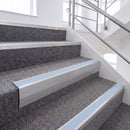Satin Silver single insert chevron stair nosing, 65mm riser with Aura insert, fitted on carpeted stairs