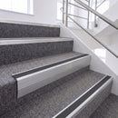 Satin Silver single insert chevron stair nosing, 65mm riser with Dark Grey insert, fitted on carpeted stairs