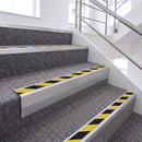 Satin Silver single insert chevron stair nosing, 65mm riser with Hazard black and yellow insert, fitted on carpeted stairs