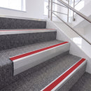 Satin Silver single insert chevron stair nosing, 65mm riser with Red insert, fitted on carpeted stairs