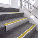 Satin Silver single insert chevron stair nosing, 65mm riser with Yellow insert, fitted on carpeted stairs
