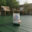Mid green anti-slip decking paint freshly applied to a garden timber deck with a paint roller and tin resting on the boards