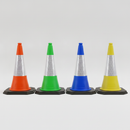 Four PVC traffic cones in orange, green, blue and yellow with reflective sleeves and black weighted bases, arranged in a row on a plain studio background
