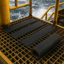 Heavy duty extra coarse anti-slip tape on offshore platform metal grating — industrial marine grade
