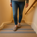 Person walking down domestic staircase with grey anti-slip PVC stair nosing on each step