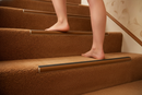 Heavy duty carpet stair nosing with Brown insert — installed on UK carpeted staircase, anti-slip protection over carpet