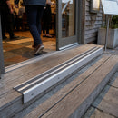 Non-slip aluminum stair nosing installed on wooden deck steps with anti-slip grip strips for safety