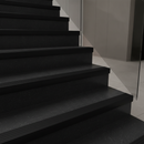 Black self-adhesive PVC stair nosing on dark wood stairs in contemporary UK home