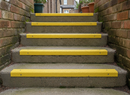 Yellow GRP non-slip strips on outdoor concrete steps — 10 year service life