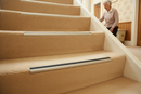 Heavy duty carpet stair nosing with Beige insert — installed on UK carpeted staircase, anti-slip protection over carpet
