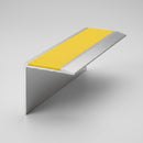 67x55mm DDA aluminium stair nosing profile with yellow anti-slip insert on a plain studio background