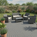 Grey interlocking WPC composite decking tiles fitted on a garden patio with rattan furniture and potted plants