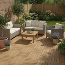 Teak brown interlocking WPC composite decking tiles fitted on a garden patio with rattan sofa and coffee table