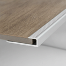 Close-up of aluminium U-channel LVT edging profile gripping cut edge of 5mm luxury vinyl tile