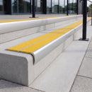 Mill finish 84mm double channel bullnose aluminium stair nosing with twin Brimstone yellow gritted exterior-grip inserts fitted on leisure centre entrance steps