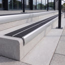 Mill finish 84mm double channel bullnose aluminium stair nosing with twin Coal black gritted exterior-grip inserts fitted on leisure centre entrance steps