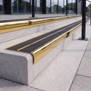 Mirror polished gold 84mm double channel bullnose aluminium stair nosing with twin Coal black gritted exterior-grip inserts fitted on leisure centre entrance steps