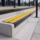 Satin black 84mm double channel bullnose aluminium stair nosing with twin Brimstone yellow gritted exterior-grip inserts fitted on leisure centre entrance steps