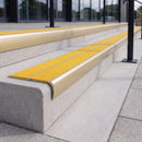Satin gold 84mm double channel bullnose aluminium stair nosing with twin Brimstone yellow gritted exterior-grip inserts fitted on leisure centre entrance steps