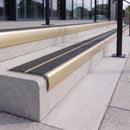 Satin gold 84mm double channel bullnose aluminium stair nosing with twin Coal black gritted exterior-grip inserts fitted on leisure centre entrance steps