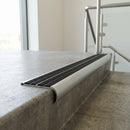 Bullnose double channel aluminium stair nosing 98x40mm fitted to a concrete step, twin Black Castellated inserts