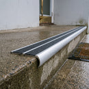 Bullnose double channel aluminium stair nosing 98x40mm fitted to a concrete step, twin Black Anti-Slip Grit inserts
