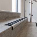 Bullnose double channel aluminium stair nosing 98x40mm fitted to a concrete step, twin Black Smooth Textured inserts