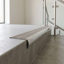 Bullnose double channel aluminium stair nosing 98x40mm fitted to a concrete step, twin Light Grey Castellated inserts