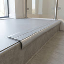Bullnose double channel aluminium stair nosing 98x40mm fitted to a concrete step, twin Light Grey Smooth Textured inserts