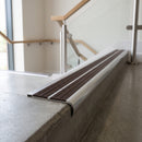 Bullnose double channel aluminium stair nosing 98x40mm fitted to a concrete step, twin Peat Castellated inserts