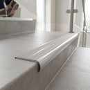 Bullnose double channel aluminium stair nosing 98x40mm fitted to a concrete step, twin Polar Grey Castellated inserts