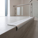 Bullnose double channel aluminium stair nosing 98x40mm fitted to a concrete step, twin Polar Grey Smooth Textured inserts
