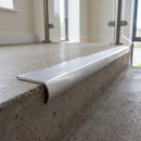 Bullnose double channel aluminium stair nosing 98x40mm fitted to a concrete step, twin Polished Aluminium inserts