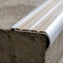 Close-up of the twin 37mm insert channels and bullnose front edge of the 98x40mm aluminium stair nosing