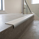 Bullnose double channel aluminium stair nosing 98x40mm fitted to a concrete step, twin White Castellated inserts