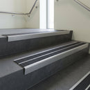 Aluminium stair nosing 90x32mm double channel fitted to a concrete step - Mill Aluminium finish with twin Black Olympic Grip inserts