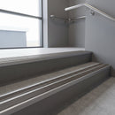 Aluminium stair nosing 90x32mm double channel fitted to a concrete step - Mill Aluminium finish with twin Granite Castellated inserts